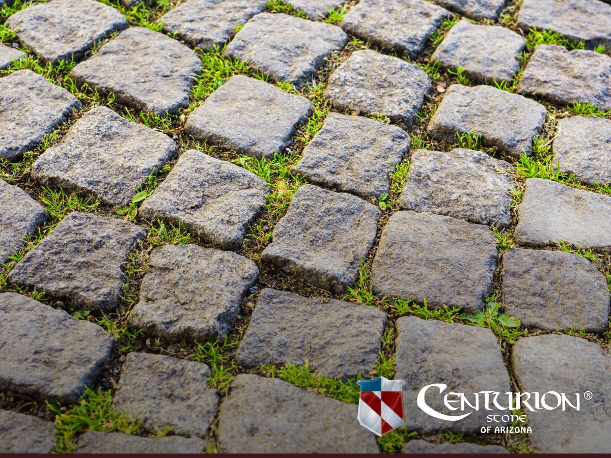 Close-up view of durable Stone Pavers with grass growing between the joints